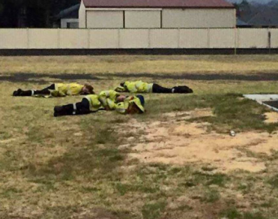Exhausted firefighters take a nap after conditions eased. Photo: ABC/Mick Reynolds