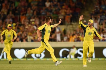 Australia's Kane Richardson celebrates his wicket of India's Ajinkya Rahane, caught by captain Steve Smith off a Richardson delivery. 