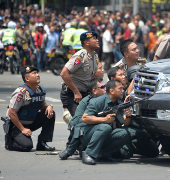 Indonesian police pursue suspects on scene.
