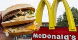 A McDonald's Big Mac, their signature sandwich is held up near the golden arches at a McDonalds's August 10, 2015, in Centreville, Virginia. AFP PHOTO/PAUL J. RICHARDS (Photo credit should read PAUL J. RICHARDS/AFP/Getty Images)