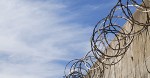 Razor wire against blue sky
