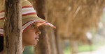 African woman in sunhat at beach