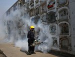 A health worker fumigates to prevent the virus spreading in Peru.