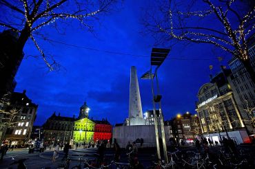 The Royal Palace at Dam Square in Amsterdam displaying the colors of the Belgian flag in tribute to the victims.