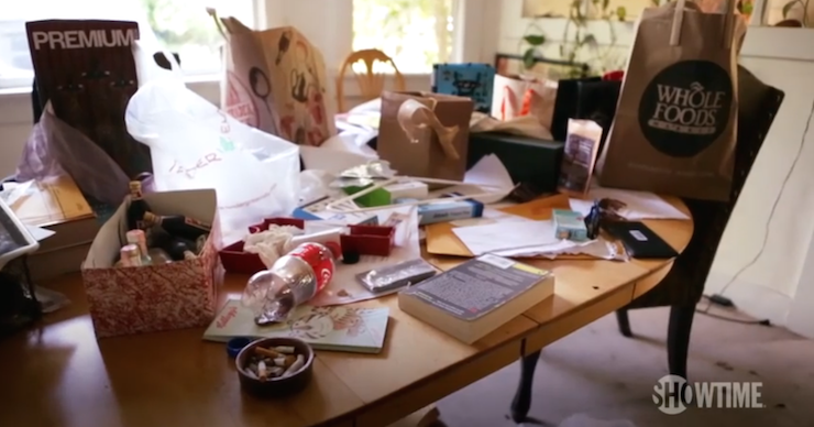 Rousey's living room table features shopping bags, coke bottles and cigarette butts.
