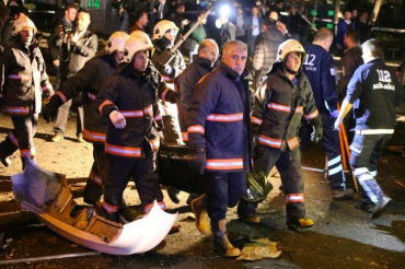 Officials with a bodybag at the scene. Photo: AFP