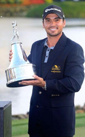 The Aussie celebrates with his trophy on Monday. Photo: Getty