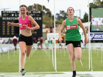 Talia Martin (pink) wins the women's 120-metre Stawell Gift final.