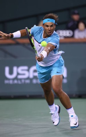 Nadal returns a ball during his three-set win over Muller. Photo: Getty