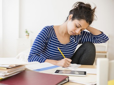 Asian student studying at table