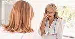 Mature woman looking in the mirror