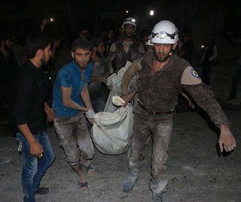 Syrians carry a body from the site of the attack. Photo: Getty/Supplied