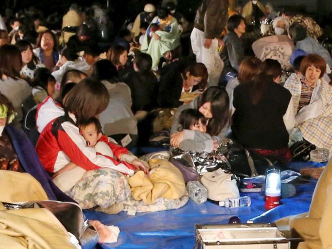 Evacuees gather in front of the town office building after escaping homes after the earthquake struck.