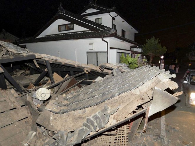 A collapsed house is seen after an earthquake in Kumamoto.