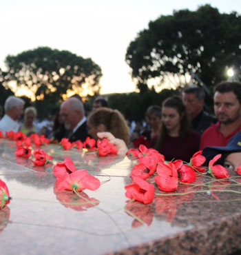 Poppies are laid on Darwin's War Memorial during the dawn service.