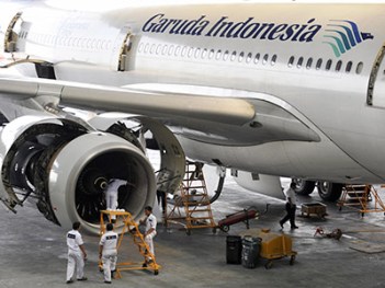 Aircraft technicians check the Rolls Royce engine of Garuda Indonesia's Airbus A330-300 aircraft at the company hangar in Jakarta airport on July 15, 2009. Indonesia, hoping for an upturn in European tourism, welcomed the EU's decision to remove four Indonesian airlines including crash-blighted Garuda Airlines from its aviation blacklist. Once reeling from a spate of deadly accidents, flag-carrier Garuda said it planned to resume flights to Europe as early as next year, and is also eyeing the lucrative US market. AFP PHOTO/ROMEO GACAD (Photo credit should read ROMEO GACAD/AFP/Getty Images)
