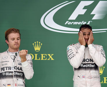 Rosberg (L) watched on as Hamilton was given the 2015 world title. Photo: Getty