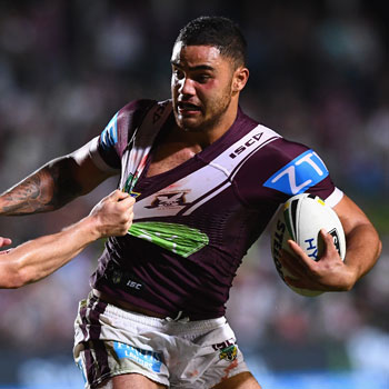 Walker fends off a tackler. Photo: Getty