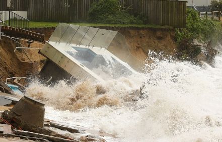 The moment when an inground pool falls into the sea on Sydney's northern beaches. Photo: Getty.
