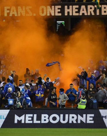 Supporters let off flares at last night's friendly. Photo: Getty.