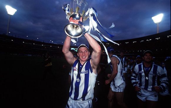 Harvey lifts the premiership cup after the Kangaroos beat Carlton in the 1999 grand final.