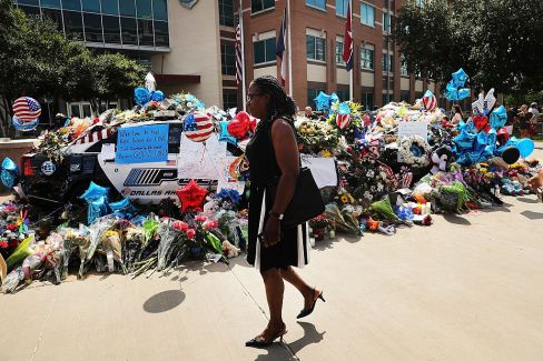 A floral tribute at the Dallas police department's headquarters. Photo: Getty.