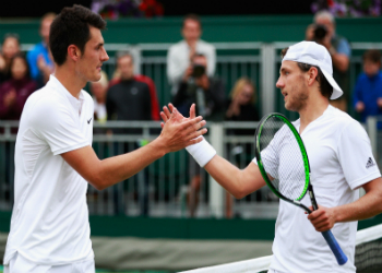 Tomic shakes Pouille's hand. Photo: Getty