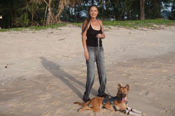 Soi Dog Foundation co-founder Gill Dalley, a double-amputee herself, fell in love with Cola and has adotped him.