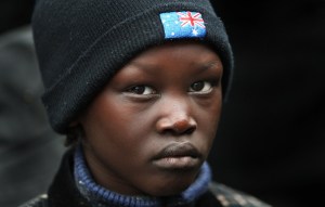A South Sudanese boy wearing an Australian hat at a Melbourne rally. Photo: William West/AFP/Getty