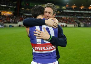 Injured skipper Robert Murphy hugs Easton Wood after the Dogs' win over the Giants.