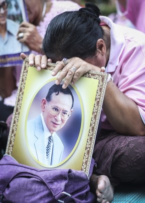 A Thai well-wisher weeps as she prays for the Thai King before his death.