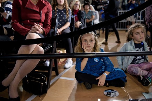 Young girls listen to Clinton's question and answer session. Photo: Getty