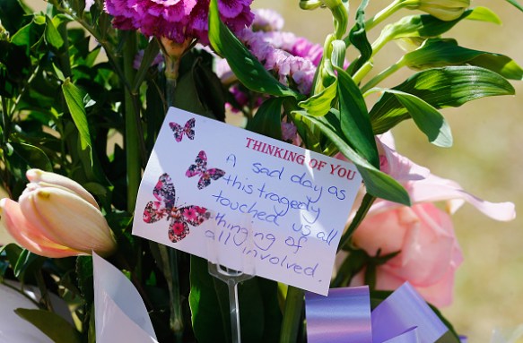 Members of the public left bouquets outside the Dreamworld gates. Photo: Getty