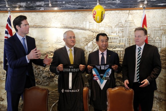 Australian Prime Minister Malcolm Turnbull, second from left, watches the ball flying past David Koch, right, chairman of Port Adelaide Football Club, and Gui Guojie, general manager of Shanghai CRED Real Estate Stock, second from right, as Gillion McLachlan, CEO of Australia Football League, prepares to catch it after a signing of the memorandum of understanding at a hotel in Shanghai, China, Thursday, April 14, 2016.