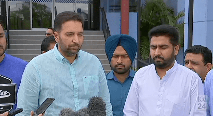 The brother of the Brisbane bus driver who was killed, Amit Alisher (R) says the attack was racially motivated.