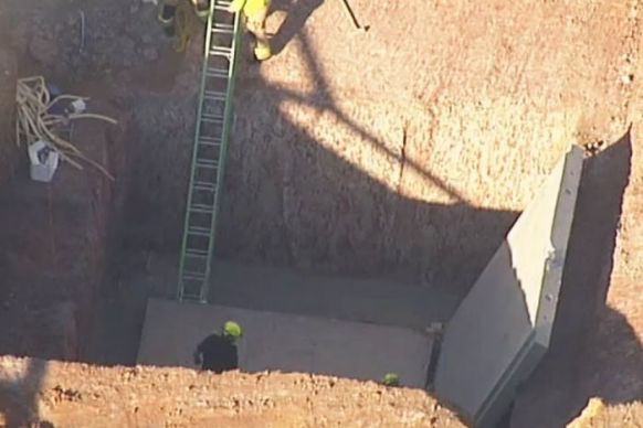 The pit where the men were standing when the slabs fell. Photo: ABC News.