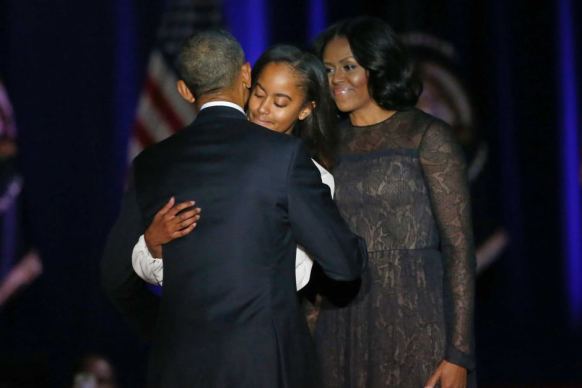Barack Obama hugs his family