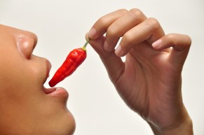 Woman eating chilli pepper