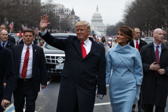 The President and First Lady wave to supporters along the parade route. Photo: Getty