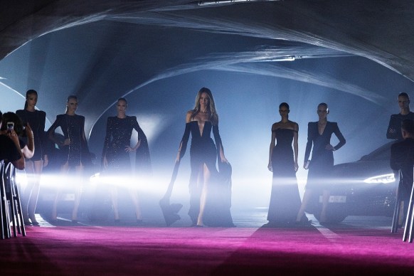 Jennifer Hawkins and her fellow models are bathed in the light of Tesla cars – Myer's latest addition. Photo: Getty