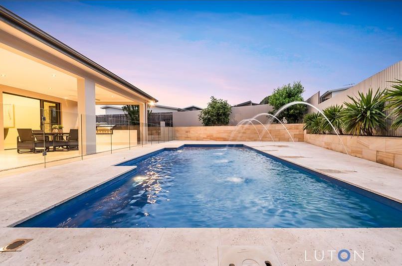 The glistening backyard pool is one of the home's drawcards. Photo: Luton