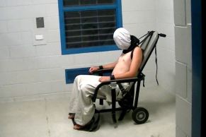 Child strapped to mechanical restraint chair
