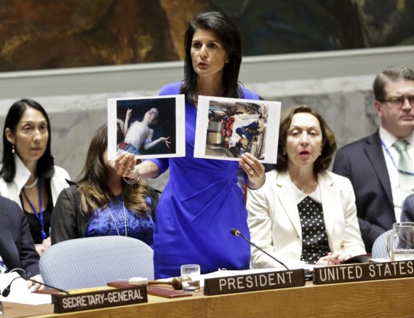 Nikki Haley, United States' Ambassador United Nations, shows pictures of Syrian victims of chemical attacks as she addresses a meeting of the Security Council on Syria at U.N. headquarters