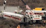Cranes salvage the last car from from a train derailment in the Bronx