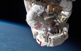 An astronaut performs a space walk on the International Space Station