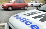 A police car monitors traffic