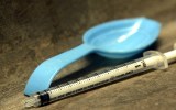 File photo of a spoon and syringe in a gutter
