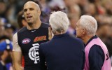 Chris Judd talks to Mick Malthouse after coming off with a hamstring injury.