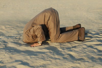 Man with head in sand