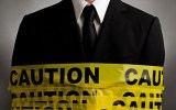 Man wrapped in tape saying caution